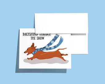 Tarjeta navideña con un perro salchicha en la nieve