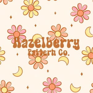 May include: A repeating pattern featuring retro-style flowers in shades of pink, yellow, and orange, along with crescent moons and diamond shapes, set against a cream background. The text "Hazelberry Pattern Co." is displayed in a retro font.
