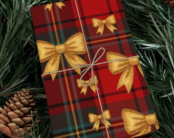 May include: A wrapped gift with a red plaid pattern and gold bows, tied with twine, rests on a bed of green pine needles and pine cones. The gift wrap features a repeating pattern of gold bows.