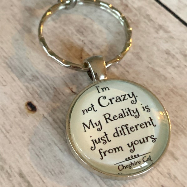 I’m not Crazy, My Reality is just different from yours… Cheshire Cat quote Cabachon pendant with extra large lobster clasp on keyring.