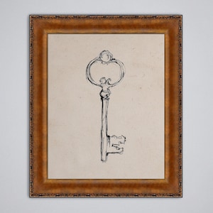 May include: A framed print featuring a sketch of an antique key. The key is drawn in black ink on a beige background, with an ornate handle and a detailed key bit. The frame is a warm, dark brown with decorative detailing.