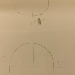 Puede incluir: Dos c&iacute;rculos dibujados a mano con medidas en pulgadas. El c&iacute;rculo superior tiene 2 7/8 pulgadas de ancho y 2 3/8 pulgadas de alto. El c&iacute;rculo inferior tiene 3,5 pulgadas de ancho y 3 5/8 pulgadas de alto.