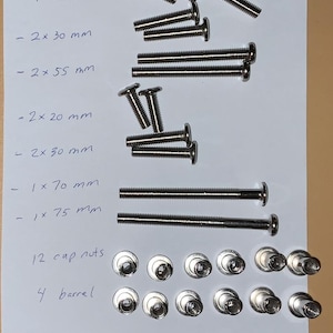 May include: Assortment of metal screws, cap nuts, and barrel nuts. The image includes various sizes of screws, including 35 mm, 30 mm, 55 mm, 20 mm, 70 mm, and 75 mm lengths. The text on the paper indicates the quantity of each item.