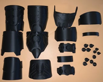 May include: A set of 17 black plastic pieces for a 3D printed robot costume. The pieces include a helmet, chest plate, shoulder pads, arm pieces, and leg pieces.