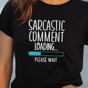 May include: Black t-shirt with white text that reads "Sarcastic Comment Loading... Please Wait" and a blue progress bar.