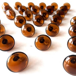 Conjunto de 29 puxadores de gaveta/armário em vidro âmbar escuro soprado à mão e latão, da Verrina Sweden, década de 1960. Peça única para renovar sua casa. Mcm Hardware.