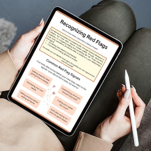 May include: A digital tablet displaying the text "Recognizing Red Flags" and "Common Red Flag Signals." The screen shows a list of red flag signals, including feeling resentful, dismissing needs, and overthinking. A white stylus is held near the tablet.