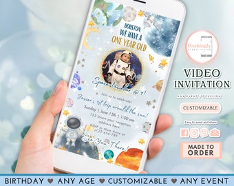 May include: A blue and white video invitation with a space theme. The invitation features a photo of a baby dressed as an astronaut, planets, stars, and the text "Spacetacular @ 1!"  The invitation is customizable and easy to send and share.