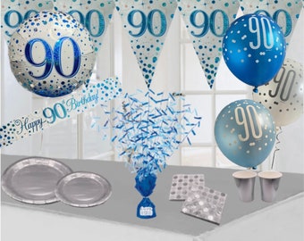 May include: A 90th birthday party decoration set with blue and silver balloons, a banner, confetti, plates, cups, and napkins. The banner says "Happy 90th Birthday!"
