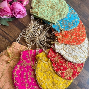 May include: A set of eight round, embroidered drawstring pouches in various colors, including green, blue, orange, white, red, pink, yellow, and peach. Each pouch features a gold floral design.