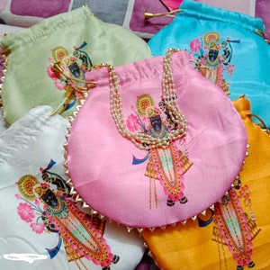 May include: Five colorful drawstring pouches with gold trim and a printed image of a Hindu deity. The pouches are made of satin fabric and have a pearl necklace attached to the top.