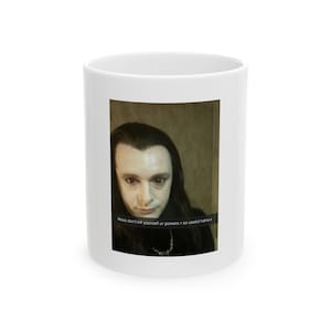 May include: White ceramic mug featuring a selfie of a person with long dark hair and pale skin. The image includes text that reads, "Nooo don't kill yourself ur powers r so useful haha x."