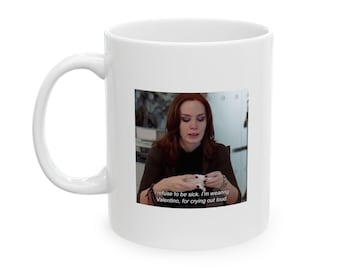 May include: White ceramic mug with a printed image of a woman holding a tissue. The image includes the text: "I refuse to be sick. I'm wearing Valentino, for crying out loud."