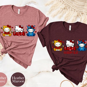 May include: Two t-shirts, one heather mauve and one heather maroon, each featuring a graphic of three cartoon characters. The characters are dressed as a bee, Hello Kitty, and Stitch, with the word "LOVE" in the center. The text "CUSTOM TEAM" is below the word "LOVE" on the maroon shirt.