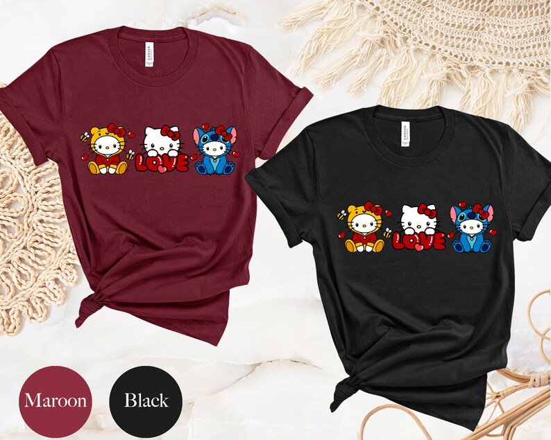 May include: Maroon and black t-shirts featuring cartoon characters in costumes with the word "LOVE" in red. The characters include a tiger, Hello Kitty, and Stitch. The shirts are short-sleeved.