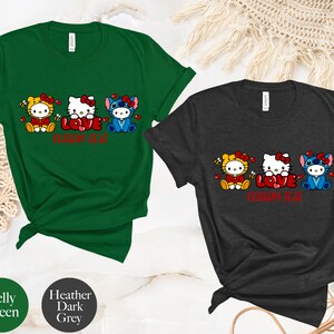 May include: Two t-shirts, one Kelly green and one heather dark grey, each featuring a cartoon design of three characters with the word "LOVE" in red. The text "CUSTOM TEXT" is below the word "LOVE".