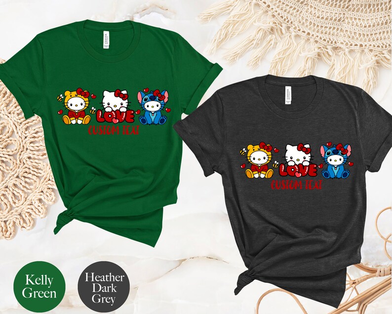 May include: Two t-shirts, one Kelly green and one heather dark grey, each featuring a cartoon design of three characters with the word "LOVE" in red. The text "CUSTOM TEXT" is below the word "LOVE".