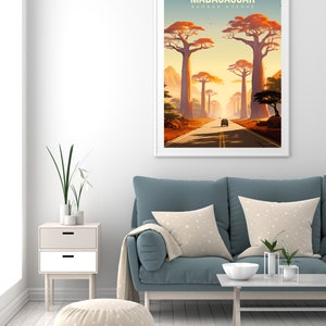 May include: A vintage travel poster with a retro design featuring a road lined with tall baobab trees in Madagascar. The poster has the text "MADAGASCAR BAOBAB AVENUE" at the top.