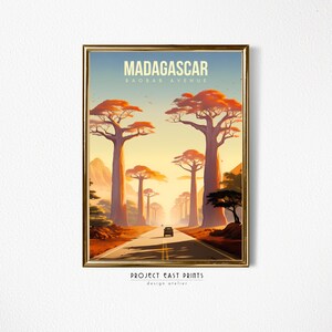 May include: A vintage travel poster with a retro design featuring a road lined with tall baobab trees in Madagascar. The poster reads "Madagascar Baobab Avenue" and "Project East Prints Design Atelier".