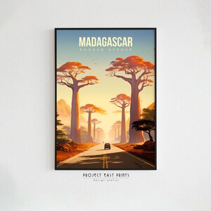 May include: A retro-style travel poster featuring a road lined with tall, orange baobab trees in Madagascar. The poster reads "Madagascar, Baobab Avenue, Project East Prints, design atelier".