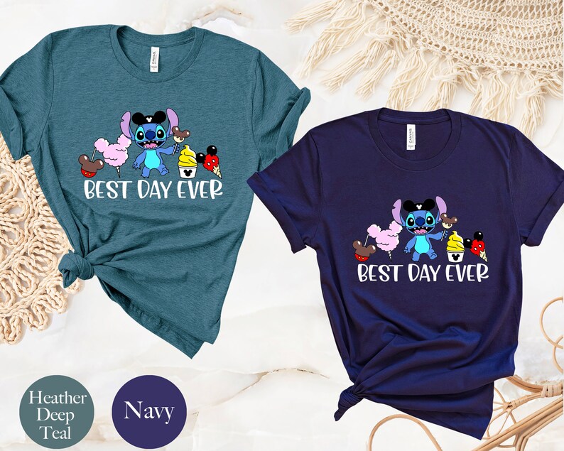 May include: Two t-shirts featuring a blue Stitch character holding various Disney treats. The text "Best Day Ever" is printed on both shirts. The shirts are available in heather deep teal and navy.