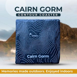 May include: A black slate coaster with a white contour map of Cairn Gorm, a mountain in Scotland. The coaster features the name "Cairn Gorm" and the elevation "1245m".