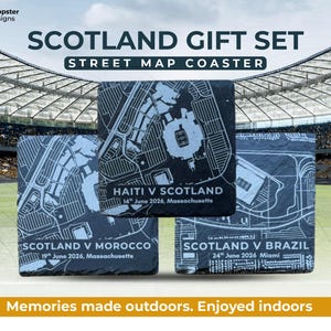 May include: A Scotland gift set featuring three black slate coasters with white street map designs. Each coaster displays a different match: Haiti vs. Scotland, Scotland vs. Morocco, and Scotland vs. Brazil, with dates and locations.