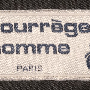 May include: White label with black text that reads "Courr&egrave;ges homme Paris" and a blue stylized logo. The label also says "Made in France".