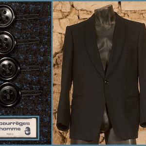 May include: A dark blue blazer with a checkered pattern and a single button closure. The blazer has a label that reads "Courr&egrave;ges homme Paris" and "Made in France".