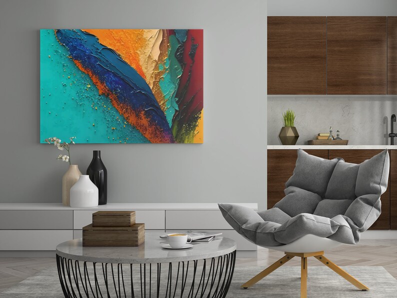 May include: Abstract painting with bold strokes of blue, green, orange, and red paint. The painting is displayed on a wall in a living room setting with a gray armchair and a coffee table.
