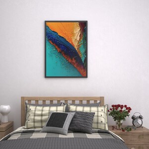 May include: A bedroom with a bed, a nightstand, a lamp, and a framed abstract painting with blue, orange, and yellow colors. The bed has a white and black plaid bedspread and pillows.
