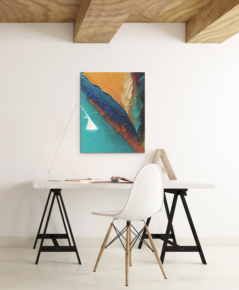 May include: A white desk with a white chair and a black lamp. The desk is made of wood and has a white top. The chair is a modern design with a white seat and wooden legs. The lamp is a simple design with a white shade and a black base. There is a painting on the wall behind the desk. The painting is abstract and features a variety of colors, including blue, green, yellow, and orange.