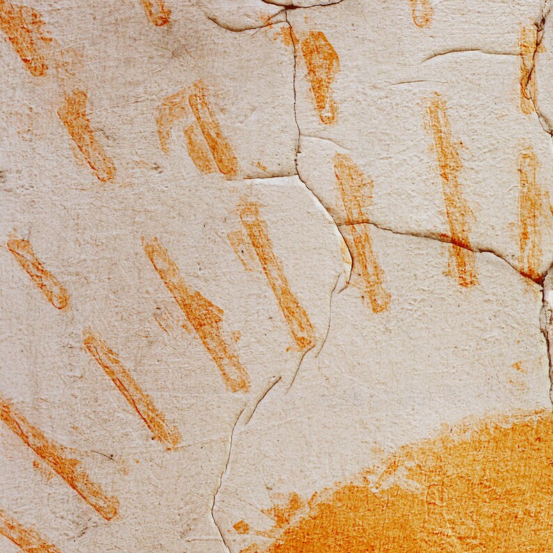 May include: Close-up of a textured, off-white surface with diagonal orange brushstrokes. The surface is cracked, revealing the underlying layers. The orange strokes vary in size and shape, creating a pattern.