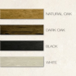 May include: A display of four rectangular wood samples in natural oak, dark oak, black, and white. The text on the right indicates the color of each sample. The samples are arranged vertically against a neutral background.