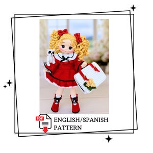 May include: A crocheted doll with curly blonde hair, red bows, and a red dress with a white collar. The doll holds a small white bag with yellow flowers and a tiny panda figure. The doll wears red boots with black laces. Text reads PDF ENGLISH/SPANISH PATTERN.