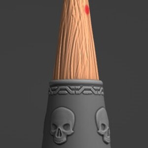 May include: A wooden, conical object with a red-painted tip. The object features a dark grey band with skull designs and decorative patterns. The base is a circular wooden platform. The overall design has a gothic or fantasy theme.