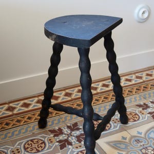 Antiker Dreibeinhocker aus gedrechseltem Holz, schwarz lackiert – Patina – Rustikale Halbmondsitzfläche – Beistelltisch aus Holz – Landhausstil
