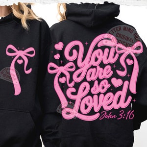 May include: Black hooded sweatshirt with a pink design that says "You are so Loved" with a heart and a bow. The text "John 3:16" is below the design.