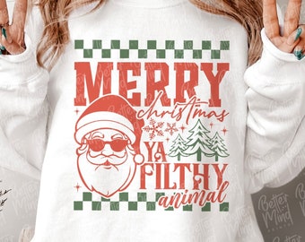 May include: White sweatshirt with a red and green graphic that says "MERRY christmas YA FILTHY animal" with a Santa Claus wearing sunglasses. The design includes a checkered pattern and Christmas trees.