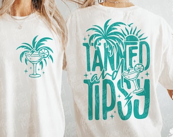May include: Off-white t-shirt with a teal graphic of a cocktail and palm tree on the front. The back features the words "TANNED and TIPSY" with a palm tree, sun, and cocktail design. The shirt is a digital download.