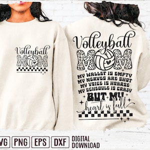 May include: A white sweatshirt with a black graphic design that says "Volleyball Mom" with a volleyball and leopard print. The text below says "My wallet is empty, my nerves are shot, my voice is hoarse, my schedule is crazy, but my heart is full."