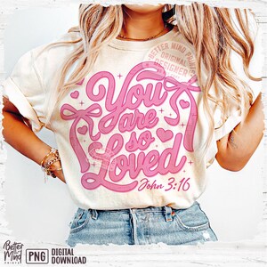 May include: A white t-shirt with a pink graphic that says "You are so Loved" with a heart and a bow. The graphic also includes the text "John 3:16".
