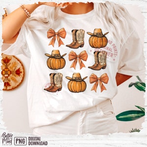 May include: A white t-shirt with a design of pumpkins, cowboy boots, and bows. The text "Original Designer" is written in a circle with the words "No Prints" above and "By" below.