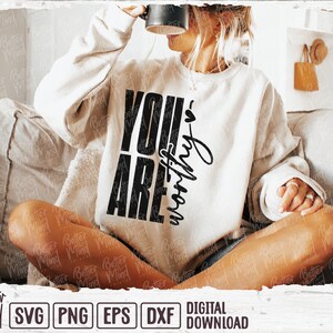 May include: Cream-colored sweatshirt with the words "YOU ARE worthy" in black. The sweatshirt is part of a digital download collection, with file formats including SVG, PNG, EPS, and DXF. The Better Mind Prints logo is visible.