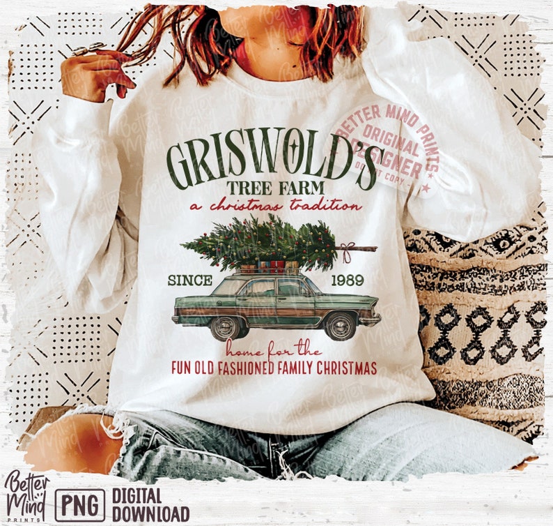 May include: White sweatshirt featuring a vintage green car carrying a Christmas tree. The text reads "Griswold's Tree Farm, a Christmas tradition, since 1989, home for the fun old fashioned family Christmas."
