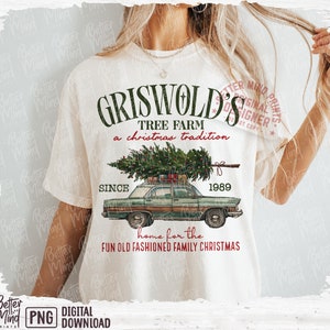 May include: Cream-colored t-shirt featuring a vintage green car carrying a Christmas tree. The shirt has the text "Griswold's Tree Farm" and "Since 1989" in green, with "a Christmas tradition" and "home for the fun old fashioned family Christmas" in red.