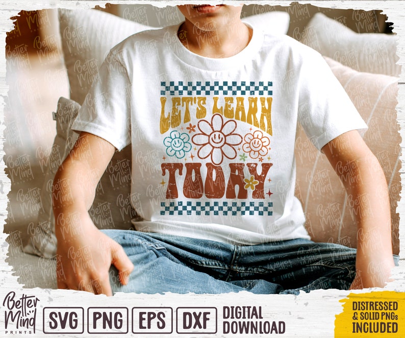 May include: A white t-shirt with a retro design featuring the text "Let's Learn Today" in a colorful, groovy font with flower accents.