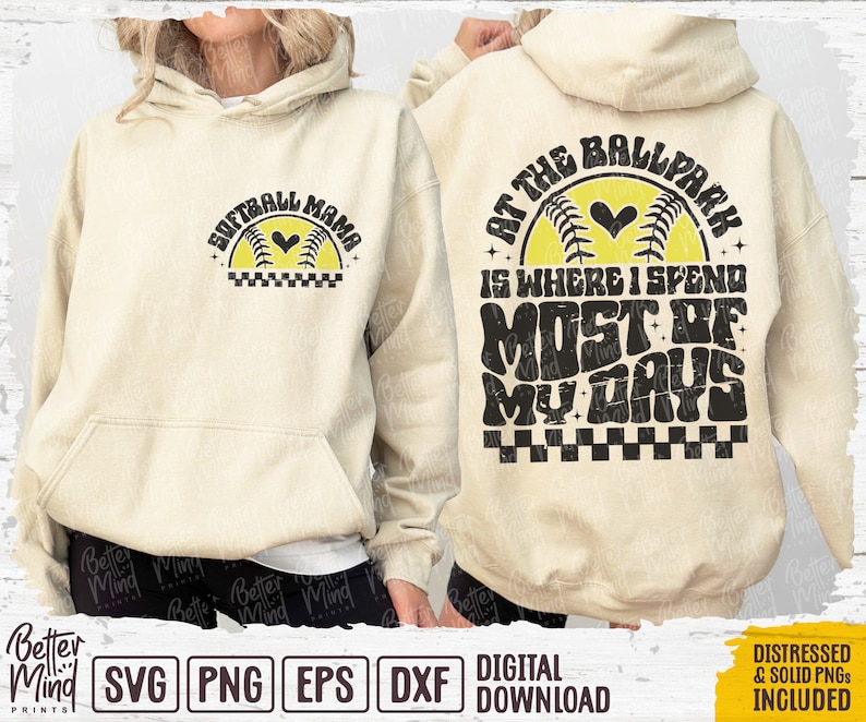 May include: A beige hoodie with a graphic design on the front that says "Softball Mama" and a graphic design on the back that says "At the Ballpark is where I spend most of my days".