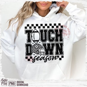 May include: White hoodie with a black and white graphic design that says "Touchdown Season" with a football and helmet.