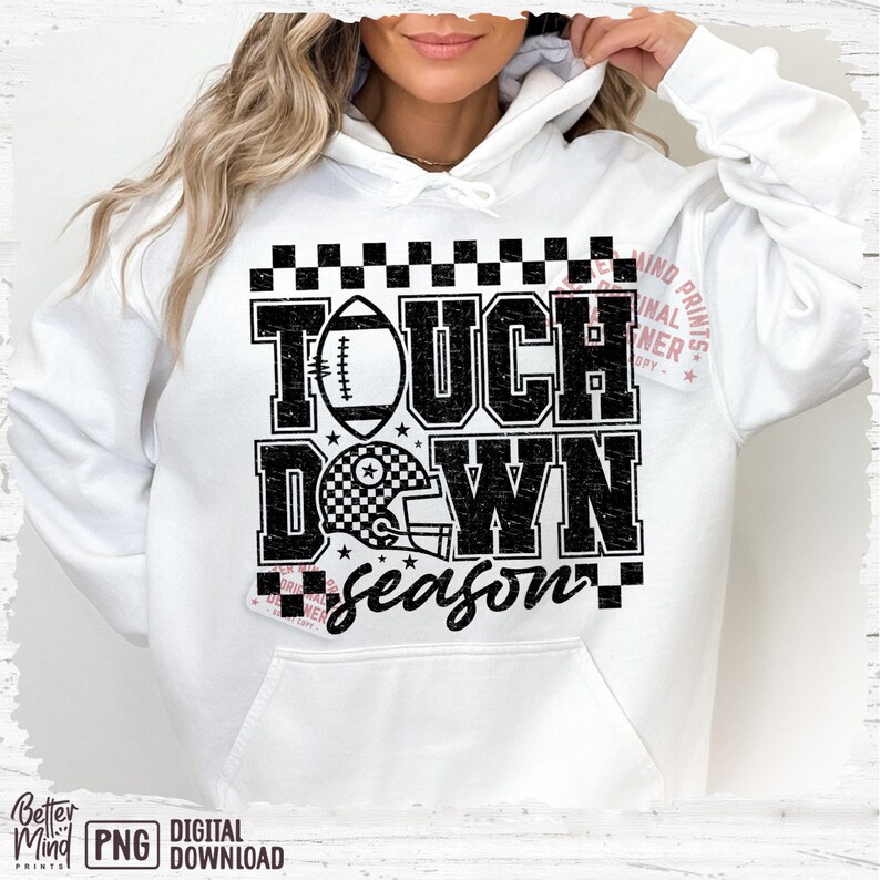 May include: White hoodie with a black and white graphic design that says "Touchdown Season" with a football and helmet.